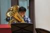 A student from the Sixth Form College is playing the tuba in the rehearsalS