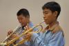 Two trumpet students are playing the first melody of the piece.