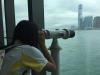 A student was viewing the Victoria Harbour in the viewing gallery.