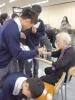 Students are assisting the elderly to play the games.