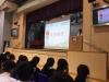 The speaker was teaching the students how to minimise the use of electricity to help saving the earth.