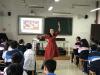 The music teacher is demonstrating a Xinjiang (新疆) folk dance to students.