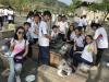 Ms. Lai and students from her class pose for a photo around their barbecue pit.