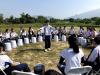 One of the students is conducting the drum circle.