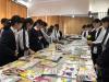 Students are reading their favourite books in the book fair.