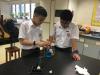 Two S1 students were trying different methods to light up the bulb.