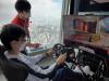 Students try to remotely control a car at Cyberport from his driving seat in SKY100.