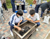 Students put their heads together, strategizing how best to get the stove lit and cooking for their outdoor meal. Teamwork and problem-solving skills are put to the test in the wilderness.