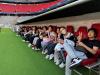 Students are sitting in the Athletes Seats in the Allianz Arena.