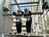 Reaching new heights! Friends enjoy an exciting day of climbing and adventure, ready to conquer the challenge with smiles and teamwork.