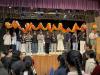 A group of students hold up the dragon and perform the dragon dance.