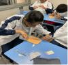 A student tries her hand at performing a surgical suture.