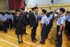 Our principal, Mr. Wong, is encouraging one of the new cadets.